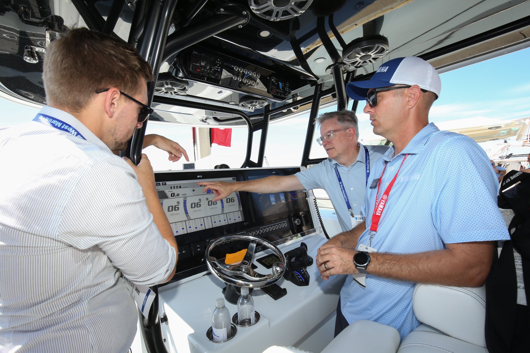 Three men at the console of a boat